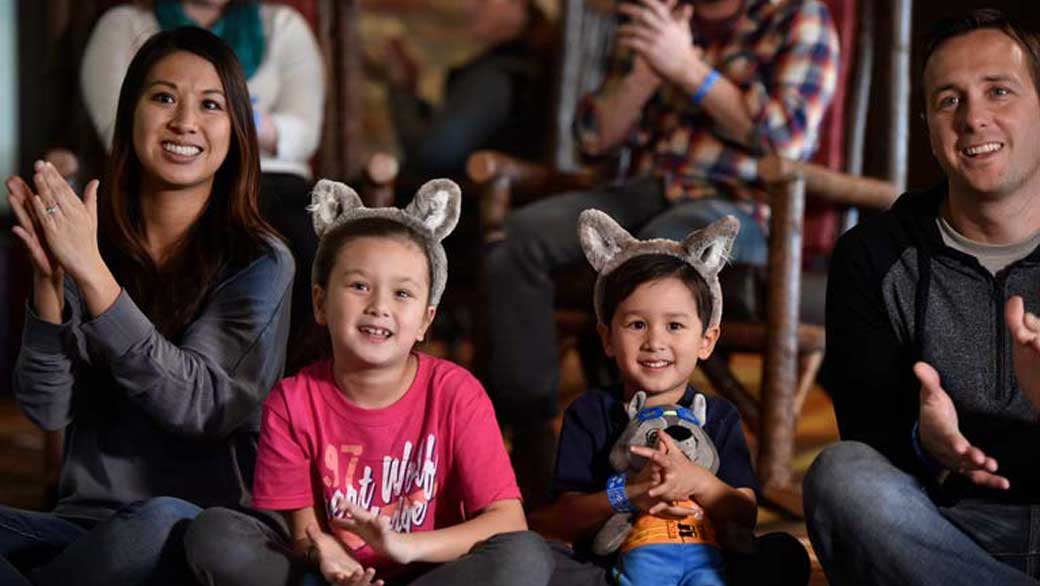 family claps as they watch the story time event