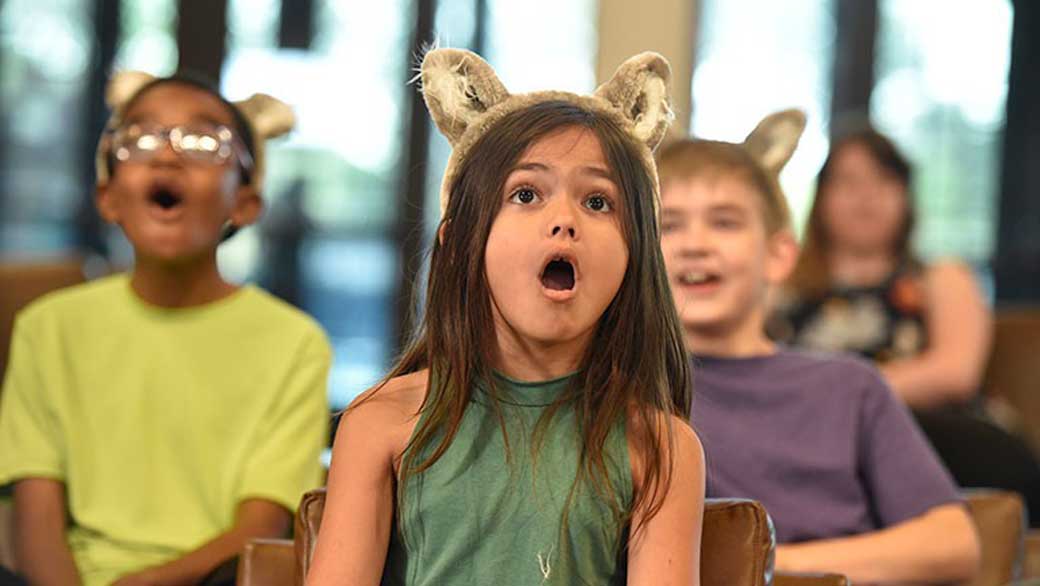 Kids look in amazement as they watch the great wolf pack movie