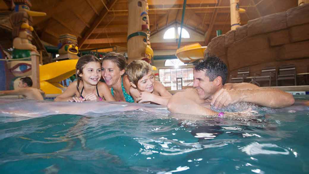 Family of four enjoying at Otter Lake at Great Wolf Lodge