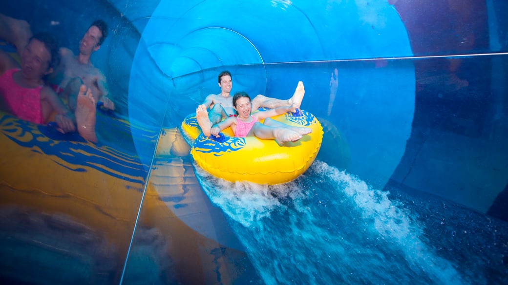 a mother and son coming down a water slide