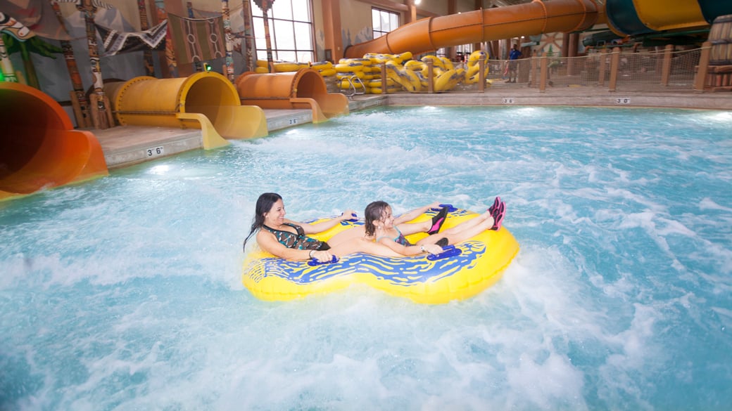 a mother and daughter in the landing pool of the water slide