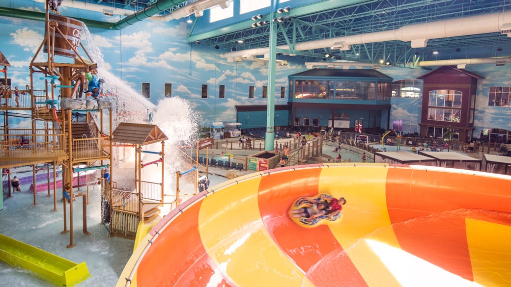 A mother and daughter ride a tube down the Coyote Cannon ride at Great Wolf Lodge indoor water park and resort.