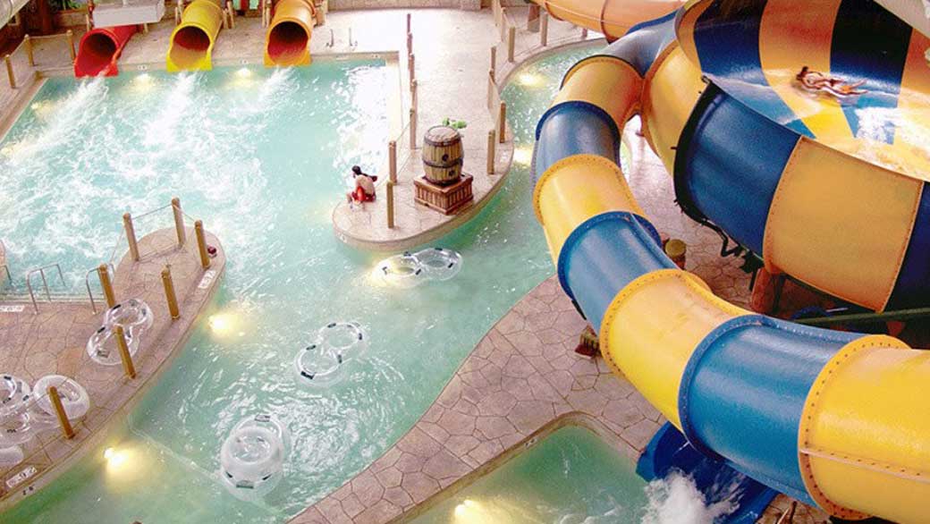 A girlt enjoying the Coyote Cannon water slide at Great Wolf Lodge indoor water park and resort.