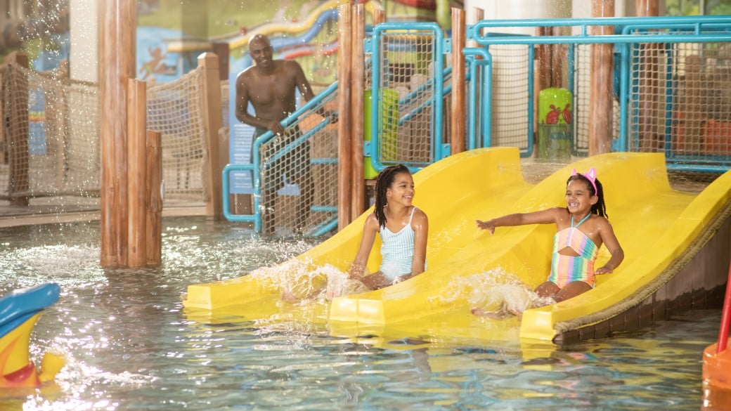 Girls having fun at Cub Paw Pool located in a Great Wolf Lodge indoor water park and resort.