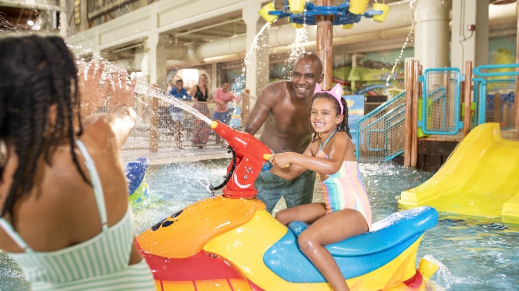 Father and two his two sons enjoying paw pool