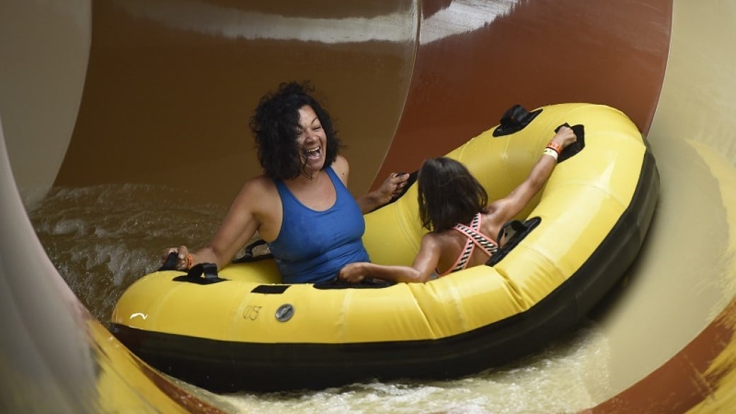 mother and daughter smiling at a water ride