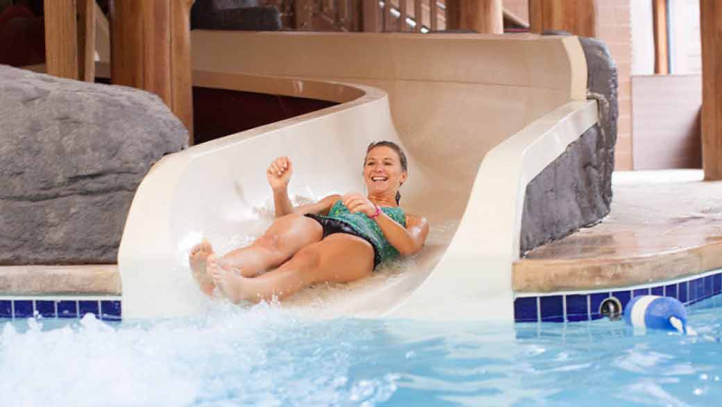 A woman screams as she rides the Mineshaft water slide