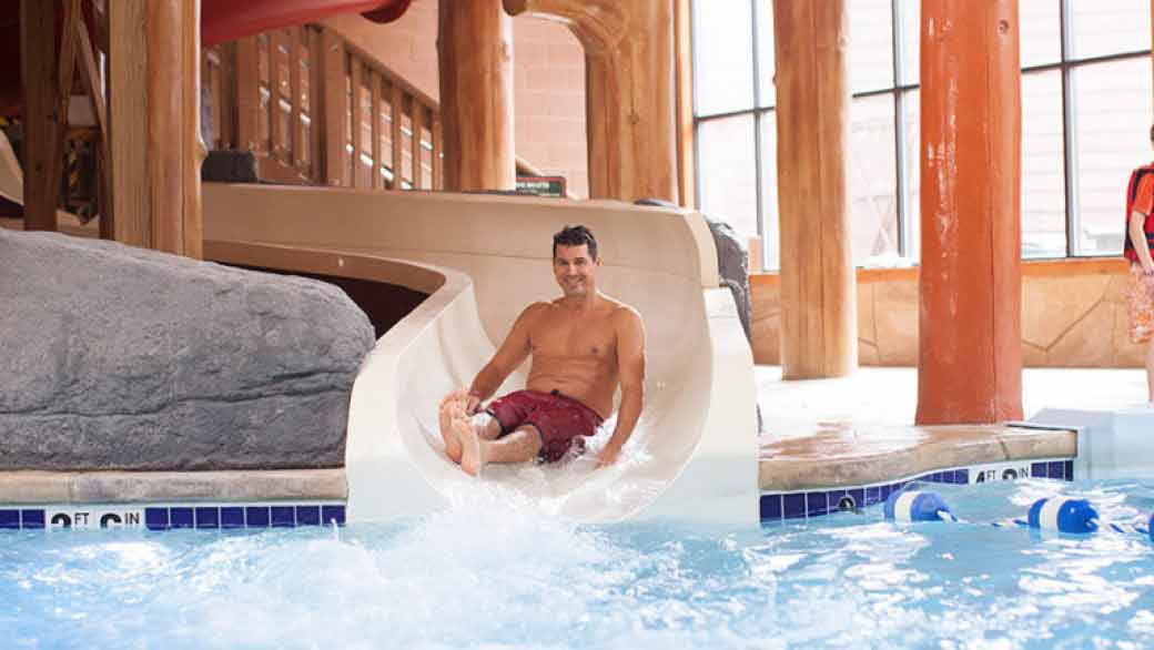 A man smiles as he rides mineshaft water ride