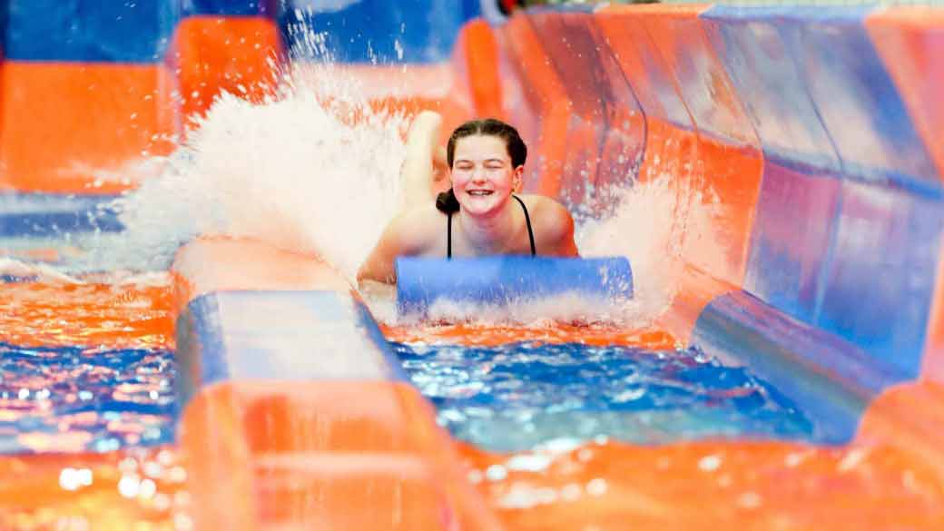 A girl looks surprised as she races down Mountain Edge Raceway