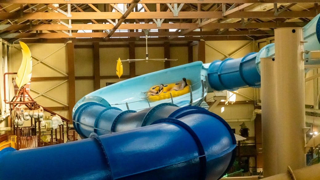 zoomed out view of two girls riding river racer waterslide