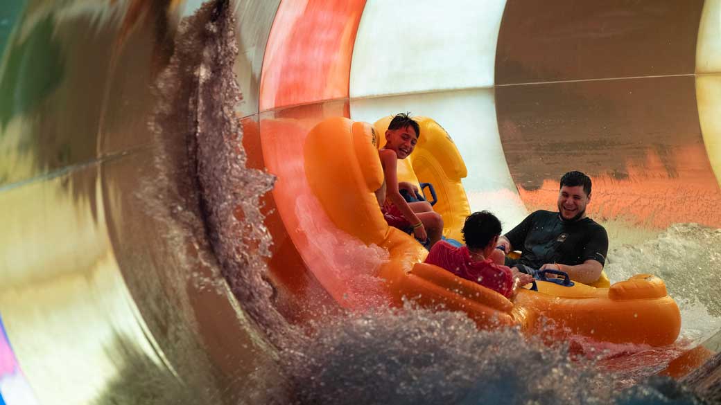 2 kids enjoy a raft ride along with there father