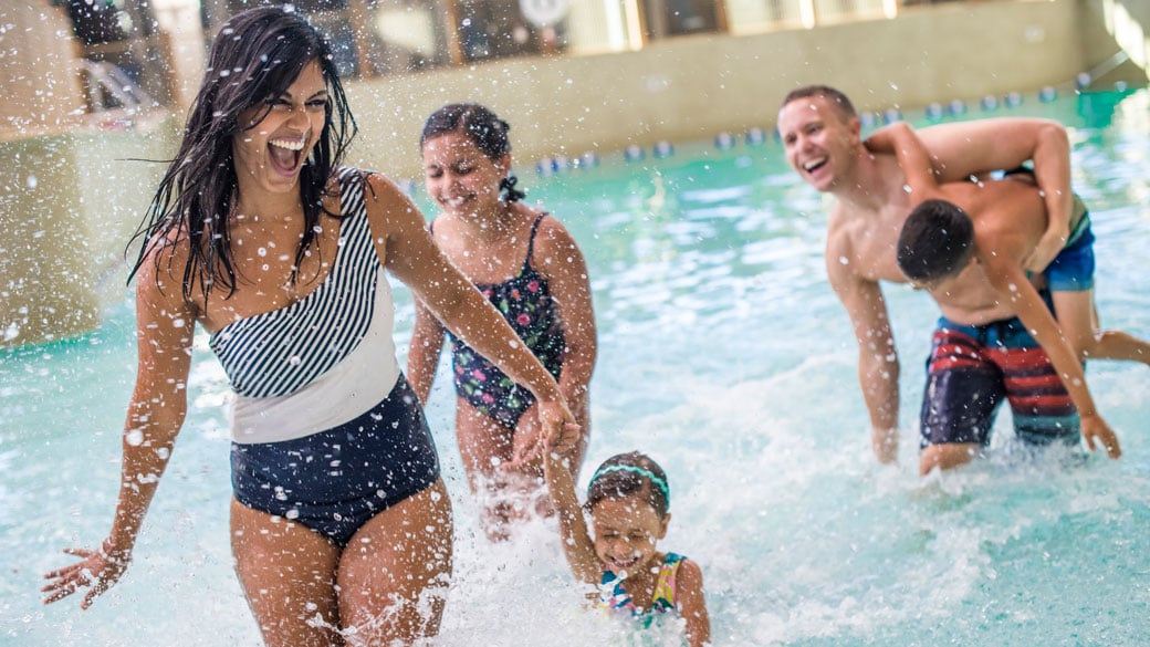 A family playing in water at Slap Tail pond