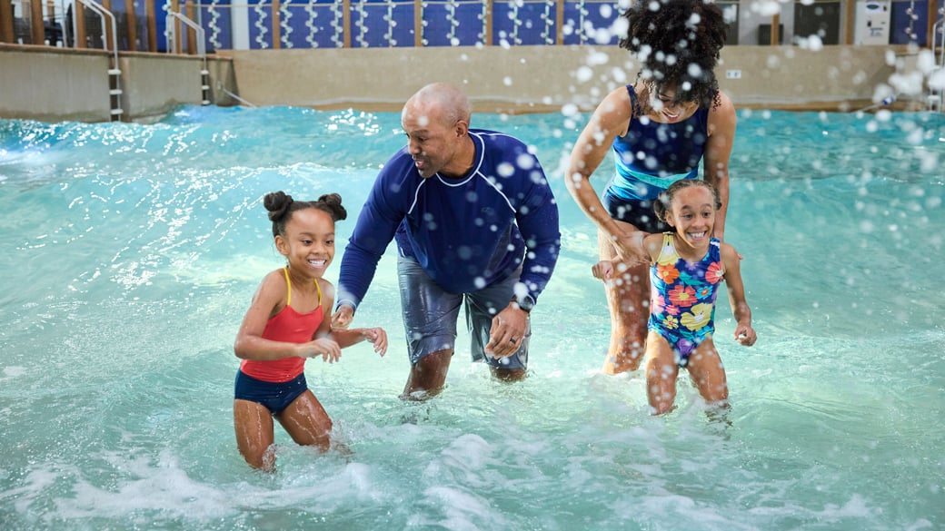 Father and daughter enjoying a wave pool at Great Wolf Lodge