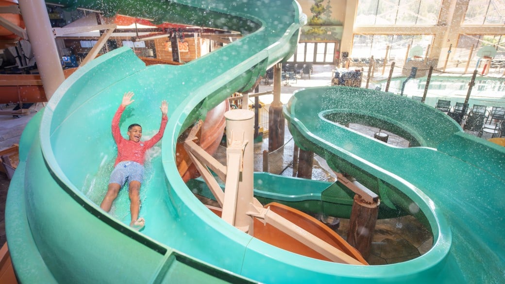 Boy coming out a water slide