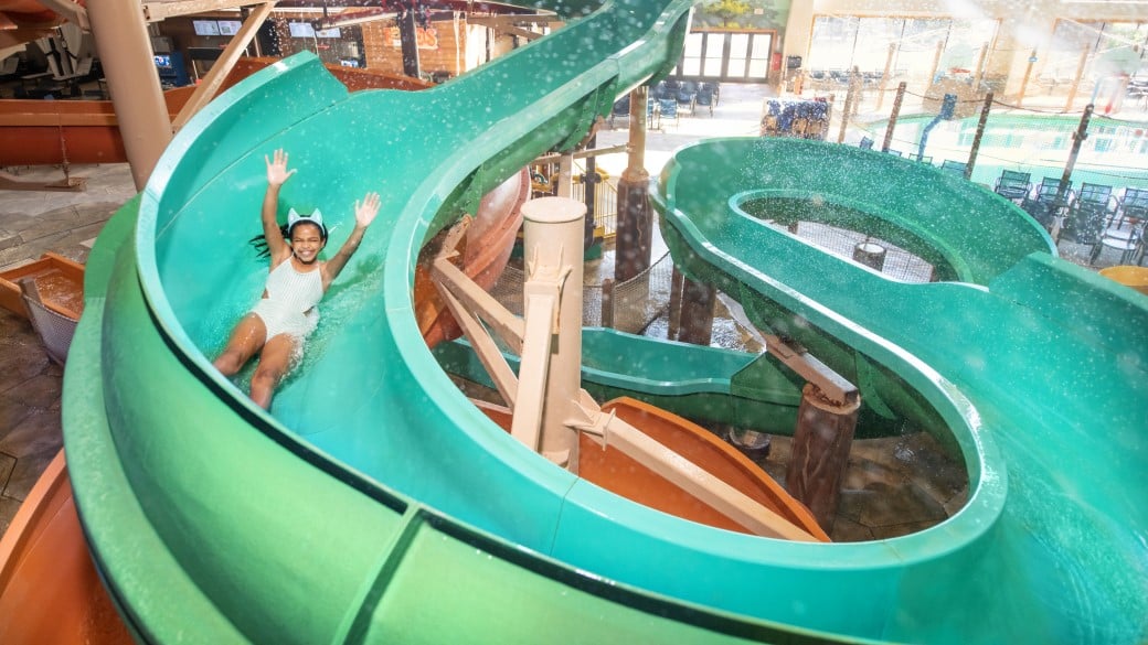 Boy coming out a water slide